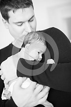 Close up father holding newborn baby, copy space background banner family parents love