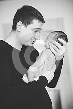 Close up father holding newborn baby, copy space background banner family parents love