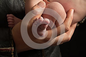 Close Up of Fathers Hands Holding Infant Son