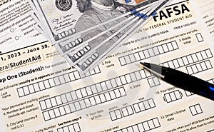 Close up of federal financial aid application with US Cash