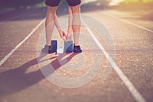 Close-up of feet of an athlete on a starting block about to run