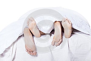 Close-up of the feet couple on bed