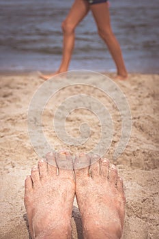 Mens feet on the beach