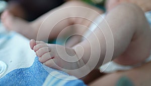 Close-up of feet of a newborn baby. Legs of a small child