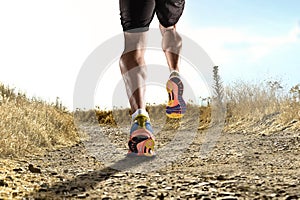 Close up feet with running shoes and strong athletic legs of sport man jogging in fitness training workout