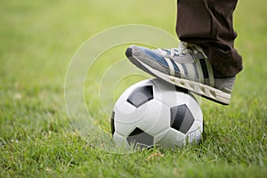 Close up of feet on top of soccer ball