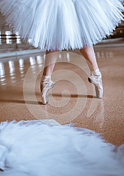 The close-up feet of young ballerina in pointe shoes