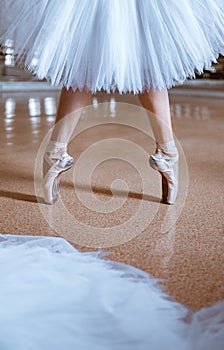 The close-up feet of young ballerina in pointe shoes