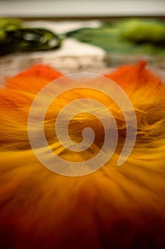 Close up of felting wool layers texture. Gradient from yellow to bright orange colors. Sheep carded wool laid out for felt project photo