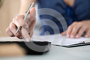 Close up of female accountant or banker making calculations