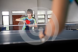 close up of female athlete preparing to serve against opponent