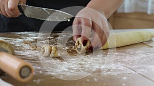 Close up female baker makes rolls with sugar cinnamon for buns slices dough roll