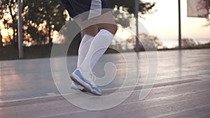 Close up of female basketball player legs in white golf socks doing dribbling exersice very quickly, run backwards