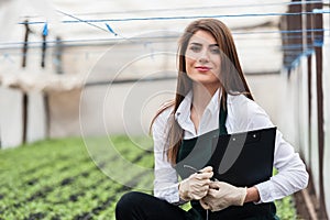 Close-up of female bio technician in greenhouse