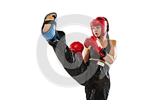 Close-up female boxer in boxing gloves and helmet training isolated on white studio background. Sport, competition