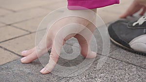Close-up of female Caucasian hands at start position. Young female runner starting her training outdoors.