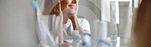 Close up of female chin and smile in mirror in bathroom. Perfect skincare concept.