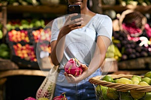 Close Up Of Female Customer At Market Stall Taking Photo Of Fresh Dragon Fruit On Mobile Phone