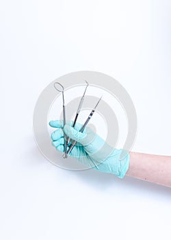 Close-up of female dentist doctor hand holding dental tools. The instruments in dental office