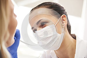 Close up of female dentist at work