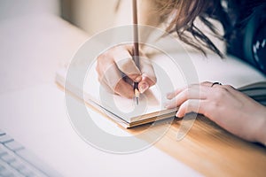 Close up of female designer hands at workplace drawing something