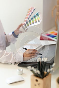 Close-up of female designer`s hands drawing