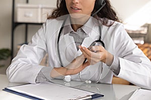 Close up of female doctor consult patient online