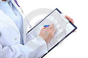 Close up of a female doctor filling up medical history form, just hands