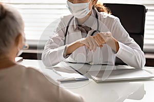 Close up of female doctor in mask consult patient