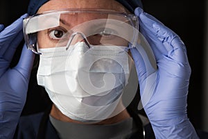 Close-Up of Female Doctor or Nurse In Medical Face Mask and Protective Gear