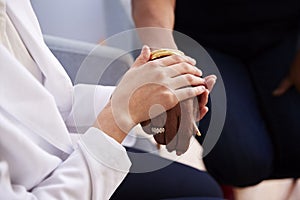 Close Up Of Female Doctor In Office Reassuring Senior Woman Patient And Holding Her Hands