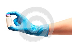 Close up of female doctor's hand in blue sterilized surgical glove holding glass ampoule with white powdered drug