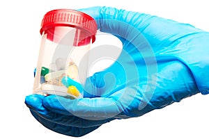 Close up of female doctor's hand in blue sterilized surgical glove holding transparent plastic sterile specimen collection contain