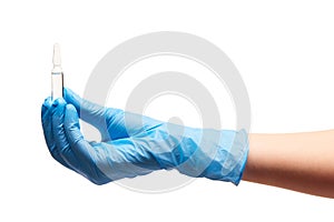 Close up of female doctor's hand in blue sterilized surgical glove holding transparent white glass ampoule with a drug
