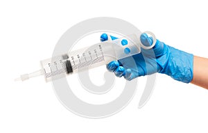 Close up of female doctor's hand in blue sterilized surgical glove with large plastic medical syringe for purging ears