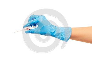 Close up of female doctor's hand in blue sterilized surgical glove with pink plastic catheter against white