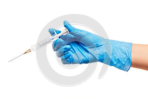 Close up of female doctor's hand in blue sterilized surgical glove with plastic medical syringe against white