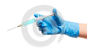 Close up of female doctor's hand in blue sterilized surgical glove with plastic medical syringe filled with blue drug