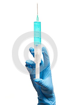 Close up of female doctor's hand in blue sterilized surgical glove with plastic medical syringe filled with blue drug