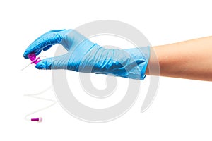 Close up of female doctor's hand in blue sterilized surgical glove with purple plastic catheter against white