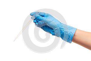 Close up of female doctor's hand in blue sterilized surgical glove with white plastic medical dropper