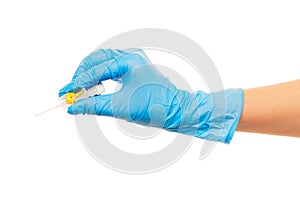 Close up of female doctor's hand in blue sterilized surgical glove with yellow plastic catheter against white