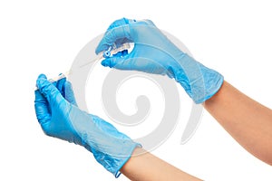 Close up of female doctor's hands in blue sterilized surgical glove with blue plastic catheter against white