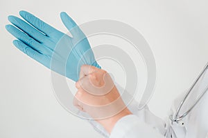 Close-Up of Female Doctor is Wearing Glove With a Stethoscope on White Isolated Background. Surgeon Occupation, Healthcare and