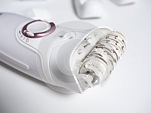 Close up female electric epilator on a white background. A concept for beauty and personal care devices