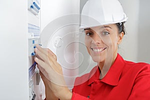 close-up female electrician working on electrical board