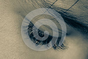 close up of female eye with makeup with tear drop on it bride