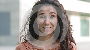 Close-up female face hispanic brunette woman girl lady standing outdoors in city looking at camera shaking head negative