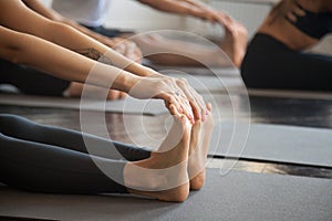 Close up of female feet, paschimottanasana pose