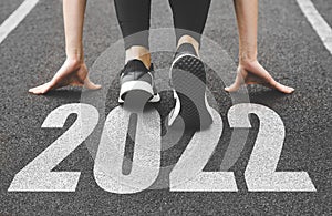 close-up of female feet in sneakers at the start. Beginning and start of the new year 2022, goals and plans for the next